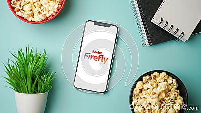 Adobe Firefly logo displayed on mobile phone screen, AI Art generator tool Editorial Stock Photo