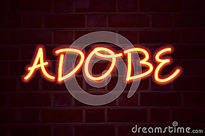 ADOBE neon sign on brick wall background. Fluorescent Neon tube Sign on brickwork Business concept for Software Company Name 3D re Editorial Stock Photo