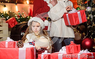 Adopting child. Kid celebrate new year with pile of gifts. Christmas traditions. Charity and kindness. To do good Stock Photo