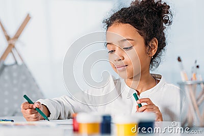 adorable african american kid painting with felt pens Stock Photo