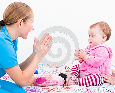 Adorable baby with babysitter Stock Photo