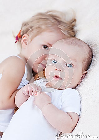 Adorable baby boy and her older sister Stock Photo