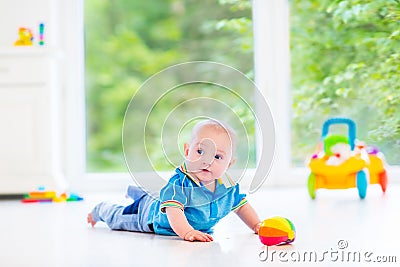 Adorable baby boy playing with colorful ball and toy car Stock Photo