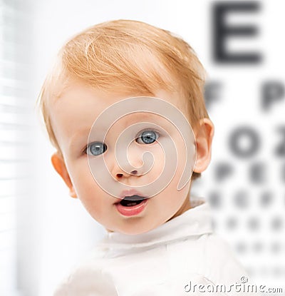 Adorable baby child with eyesight testing board Stock Photo