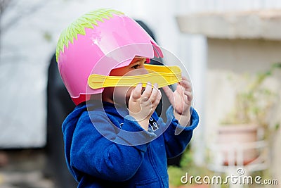 adorable baby with an easter basket for a helmet Stock Photo