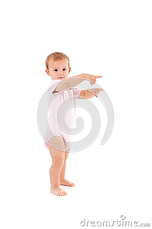 Adorable baby girl making first steps Stock Photo