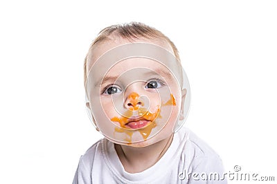 Adorable baby girl making a mess while feeding Stock Photo