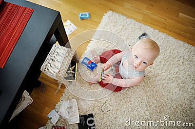 Adorable baby girl making a mess Stock Photo