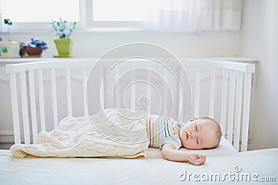 Baby girl sleeping in co-sleeper crib Stock Photo