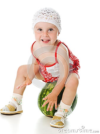 An adorable baby happily plays the watermelon Stock Photo