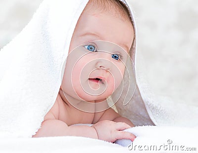 Baby under the white blanket Stock Photo