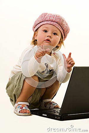 Adorable baby with laptop Stock Photo