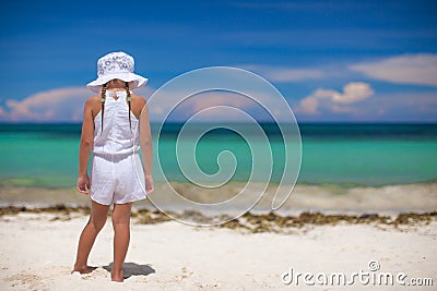 Adorable beautiful little girl alone looks at the Stock Photo