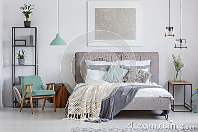 Adorable bedroom with mint chair Stock Photo