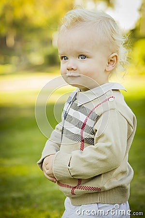 Adorable Blonde Baby Boy Outdoors at the Park Stock Photo