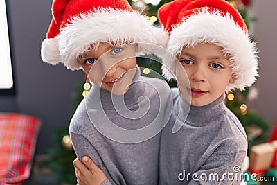 Adorable boys hugging each other celebrating christmas at home Stock Photo