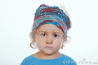 Adorable calm girl looking at camera and wearing blue handmade headband Stock Photo