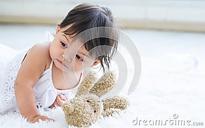 Adorable caucasian little baby daughter kid girl, laughing, smiling with happiness, good health, relax day sleeping, laying down Stock Photo