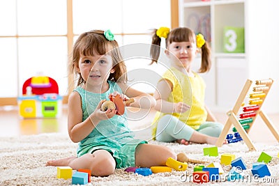 Adorable children playing colorful toys Stock Photo