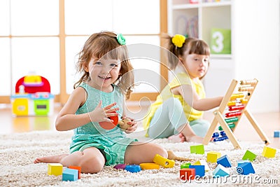 Adorable children playing colorful toys Stock Photo