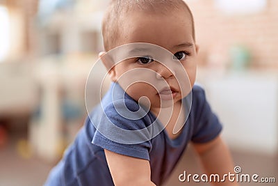 Adorable chinese toddler standing with serious expression at home Stock Photo