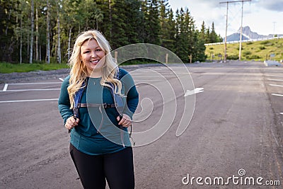 Adorable cute blonde young adult woman is ready for a hike - taken at Troll Falls parking lot in Kananaskis Country Canada Stock Photo