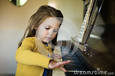 Adorable Cute Girl Playing Piano Concept Stock Photo