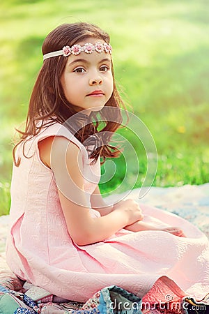 Adorable dressy child girl in spring garden Stock Photo