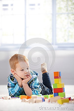 Adorable gingerish little boy with building cubes Stock Photo