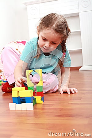 Adorable girl playing with blocks Stock Photo