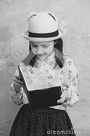 Adorable girl reading black note book Stock Photo