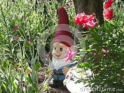 Cute Gnome With Red Hat Decoration In A Bright Green Garden Stock Photo