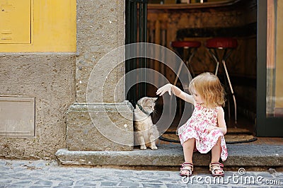 Adorable happy little girl and a cat Stock Photo