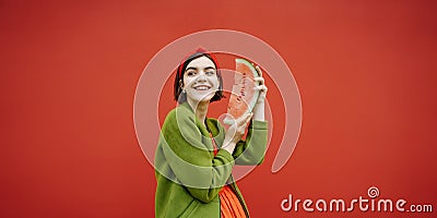 Adorable happy smiling face brunet girl holding slice of watermelon and looking side. Stock Photo