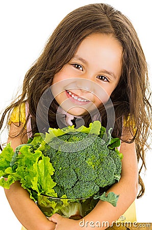 Adorable healthy little girl holding salad bowl Stock Photo