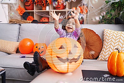 Adorable hispanic toddler having halloween party playing with foam bubbles at home Stock Photo