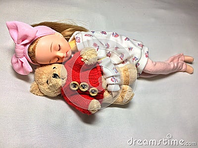 An adorable Japanese doll is sleeping with her teddy bear. Editorial Stock Photo