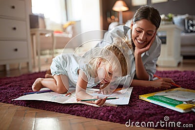 Adorable kid with female drawing indoor Stock Photo