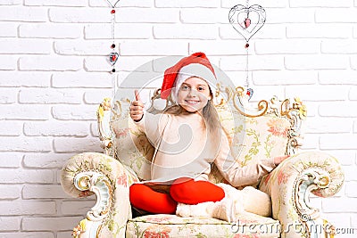 Adorable kid has rest on furniture. Girl with happy face Stock Photo