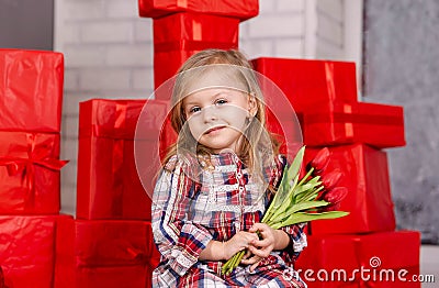 Adorable kid with a spring flower. Beautiful girl with flowers Stock Photo