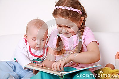 Adorable kids reading and playing Stock Photo