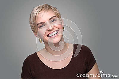 Adorable laughing lady head shot short pixie haircut modern style gray background Stock Photo