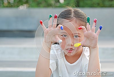 Adorable little Asian girl with colorful fingers painted Stock Photo