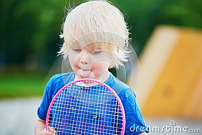 Little boy playing badminton with mom on the playground Stock Photo