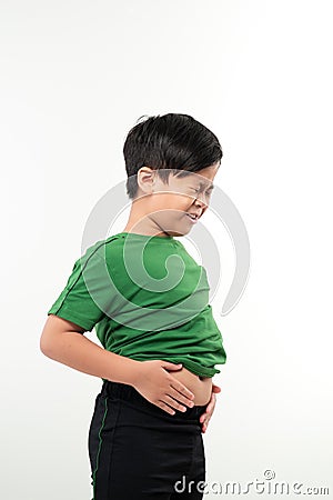 Adorable little boy suffering from abdominal pain, copy space. Young boy having stomachache Stock Photo