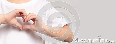 An adorable little child`s hands gesture in heart shape showing love and kindness. Concept of Health care, Charity, Organ Donatio Stock Photo