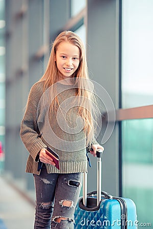 Adorable little girl at airport in big international airport near window Stock Photo