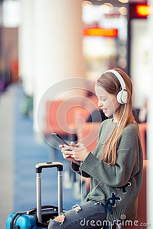 Adorable little girl at airport in big international airport near window Stock Photo