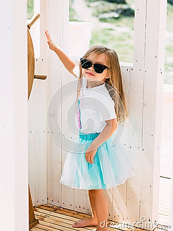 Adorable little girl enjoying sailing on a luxury catamaran or y Stock Photo