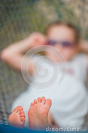 Adorable little girl in hammock outdoor at the beach Stock Photo